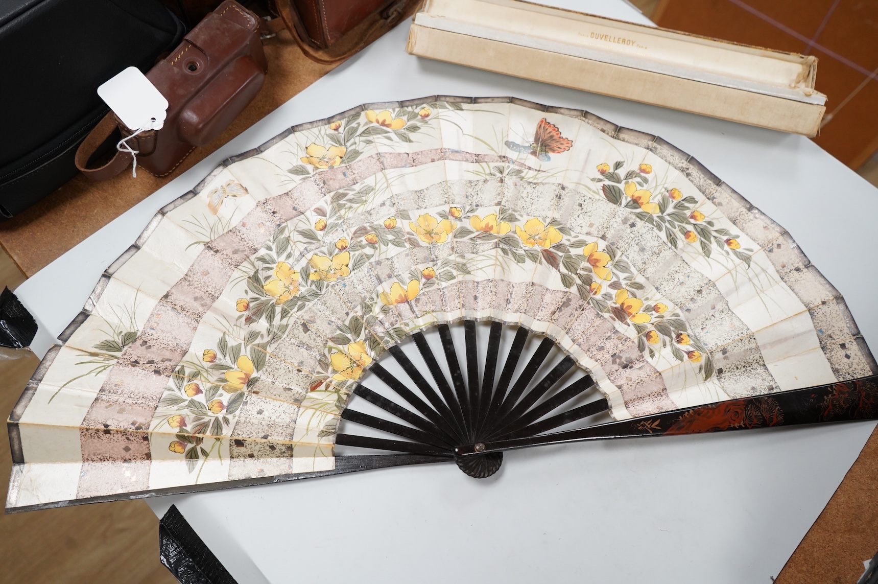 A gold mounted lace and hand painted fan and three others to include a lacquered example, one cased
